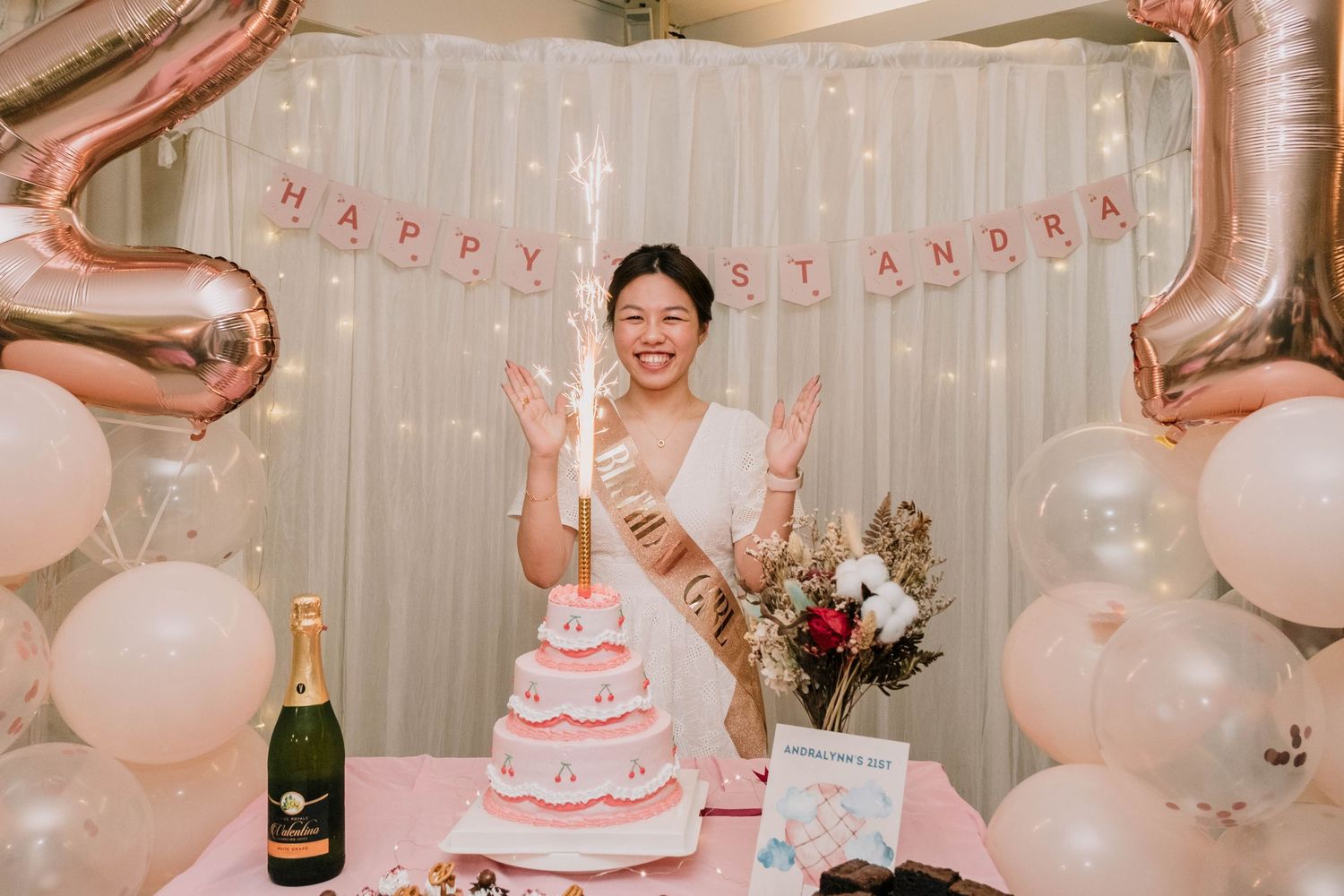 A joyous birthday celebration with large number balloons and elegant cake display.