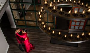 Elegant indoor photoshoot with string lights and romantic ambiance.