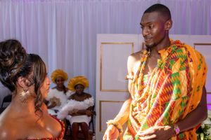 Traditional African wedding ceremony with vibrant kente cloth attire.