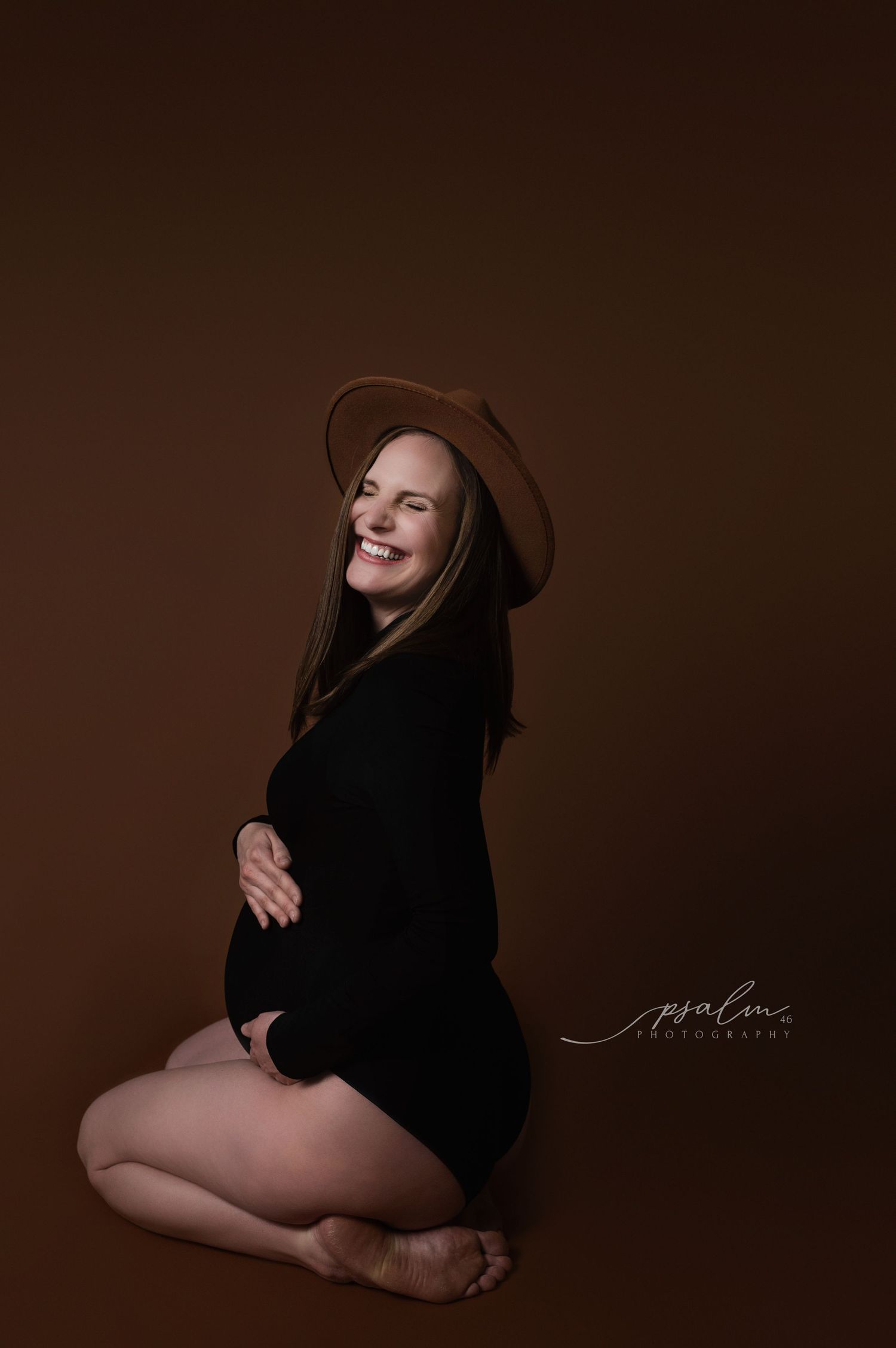 Artistic maternity photo series in black clothing against dark brown backdrop showing silhouette poses.