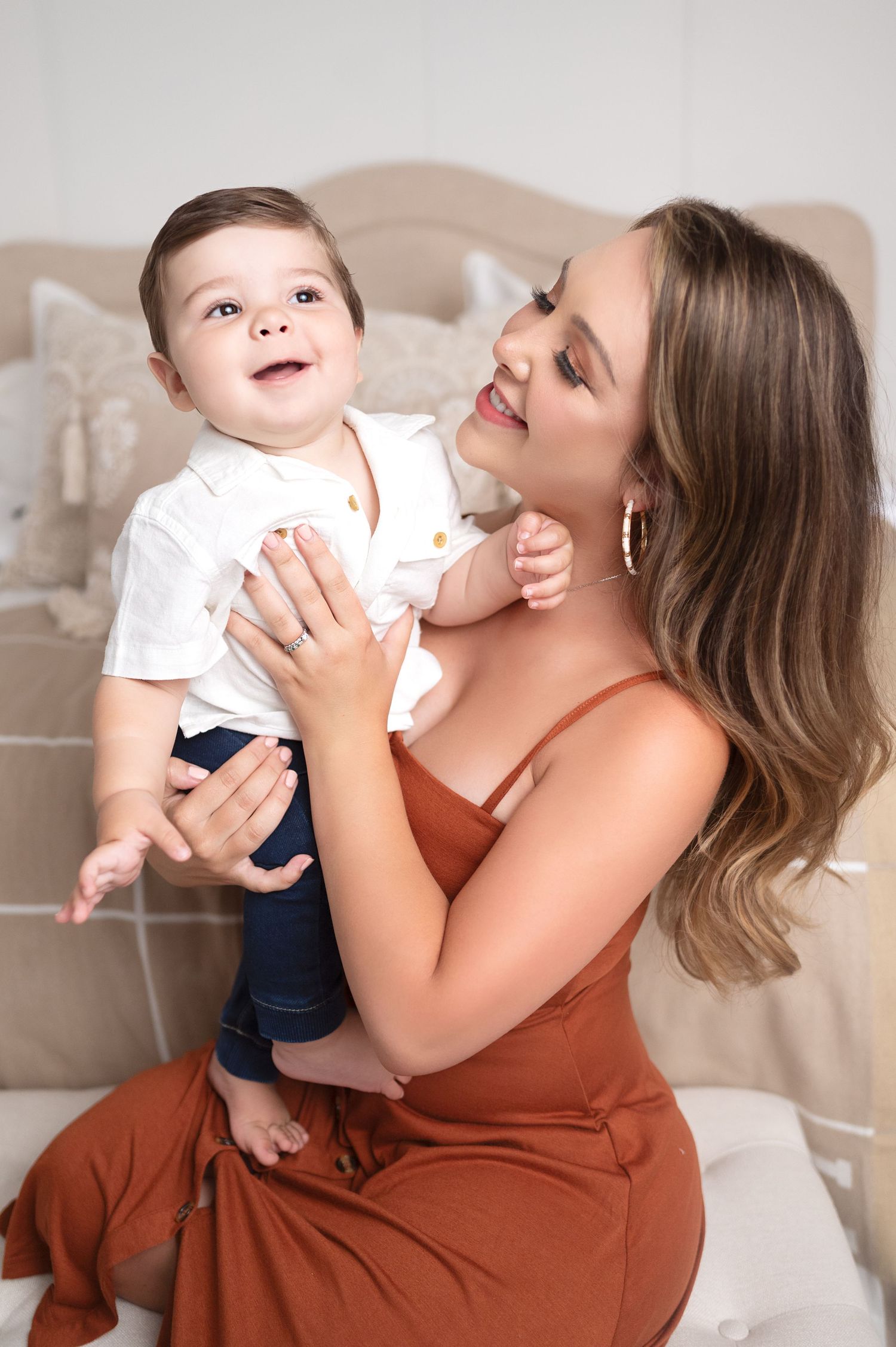Candid studio portraits capturing joyful moments between parent and child.