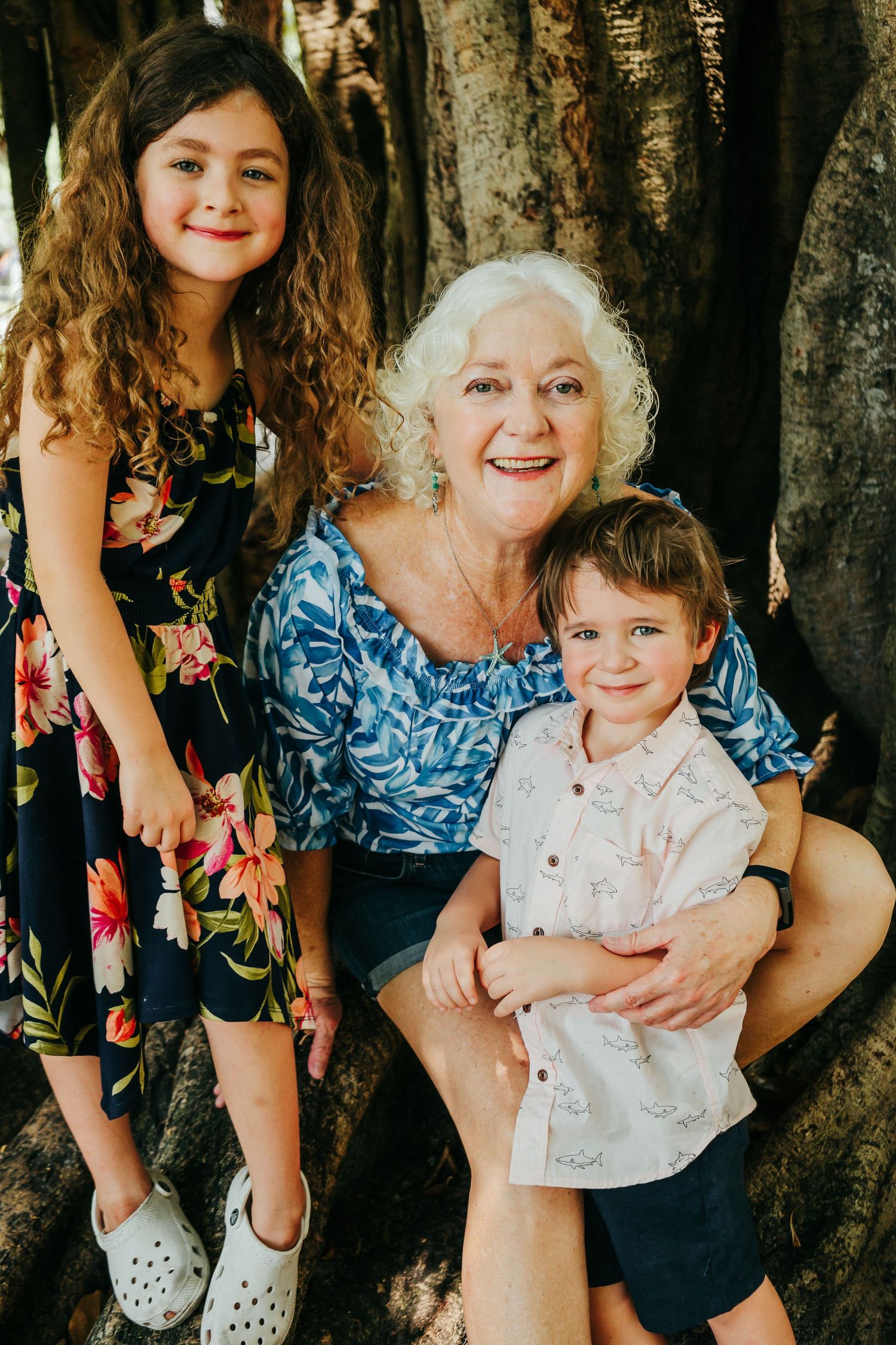 Outdoor Family Session in St. Pete, FL; Grandmother posing with grandkids near banyan trees