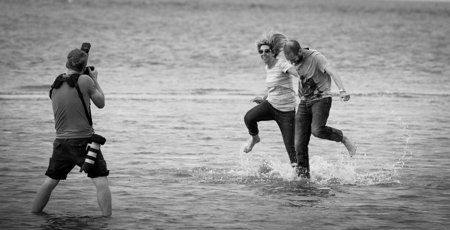 Black and white sequence of people playing and splashing in water.