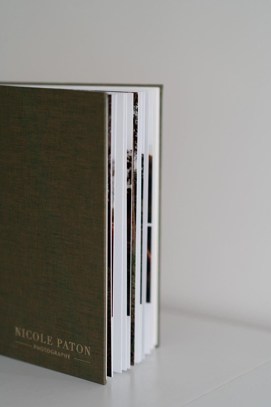 NPP memory album in forest green linen with gold embossed logo book shows thick pages