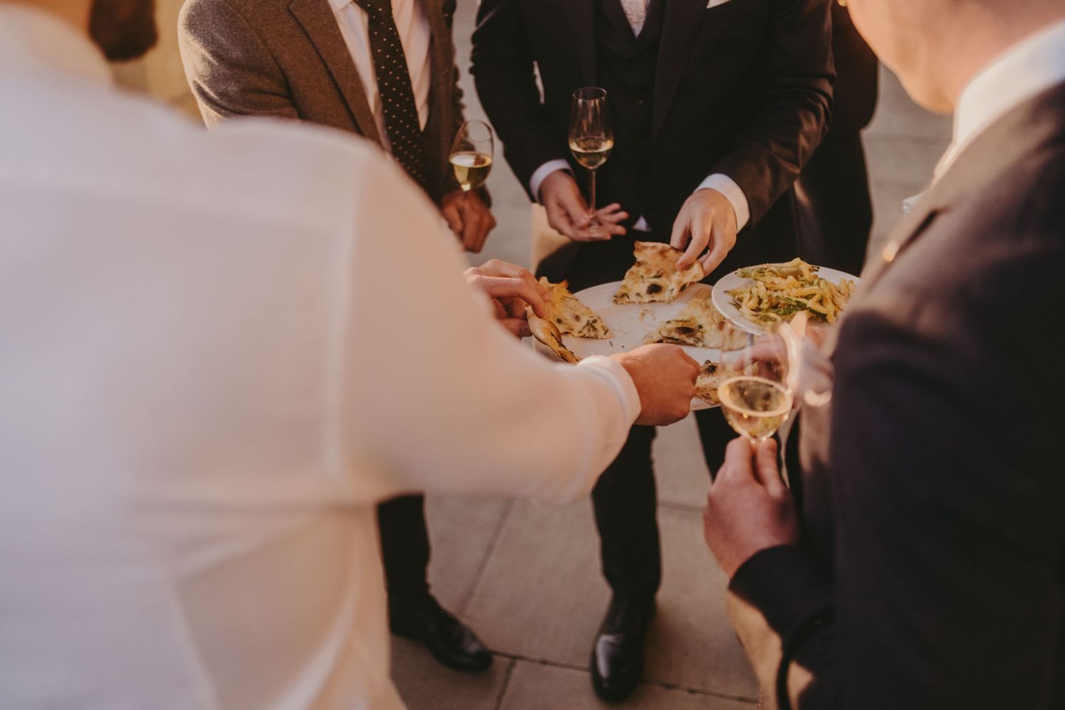 Guests gathered around sharing appetizers at evening event.