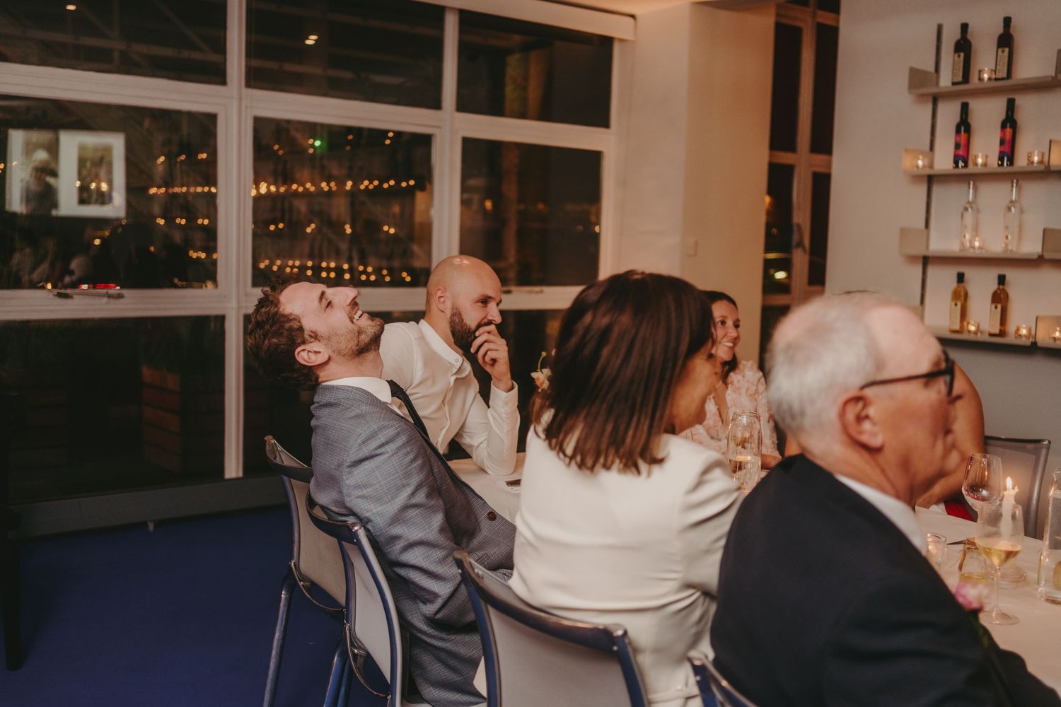 Wedding guests enjoying an intimate reception dinner in a restaurant setting.