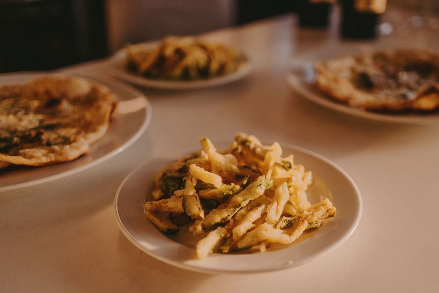 Plate of pasta served on white dinnerware at formal dining event.