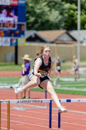 Photograph of Buffalo High School student running hurdles in track meet.