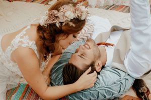 Intimate moment between newlyweds lying close together in romantic pose.