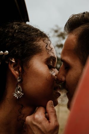 Intimate close-up of romantic couple sharing a tender moment.