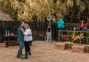 Event space set up in a desert setting with decorative balloons and string lights.