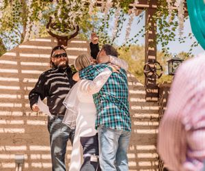 Wedding celebration in a rustic outdoor setting with decorative elements.