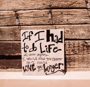 Wooden fence with graffiti writing in a desert setting.