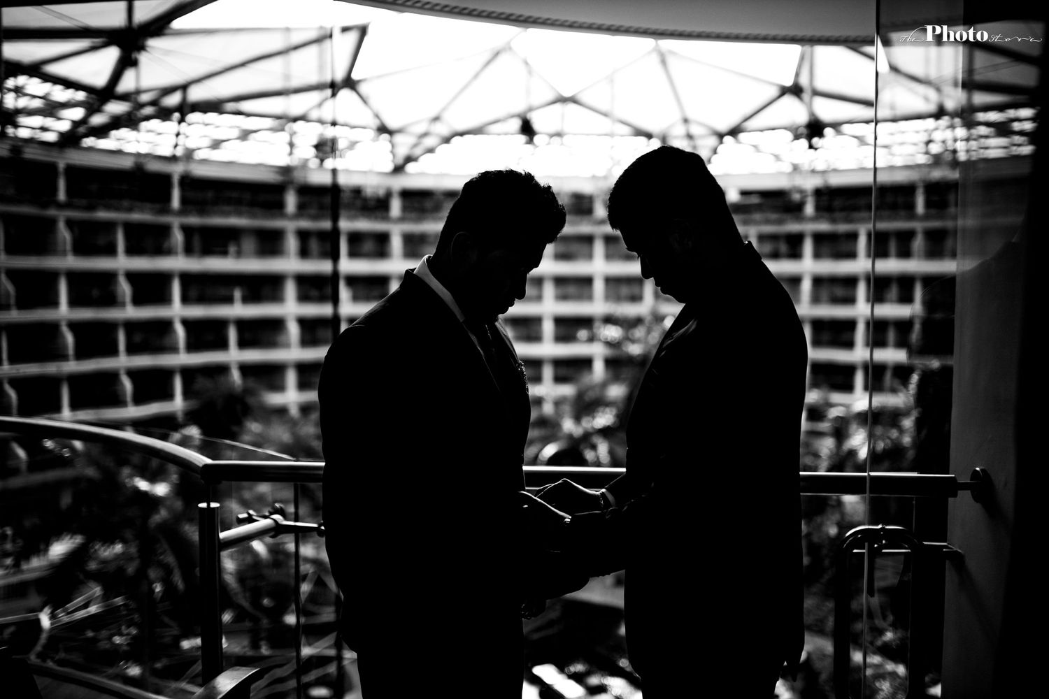 Silhouetted figures against industrial architecture with dramatic lighting.