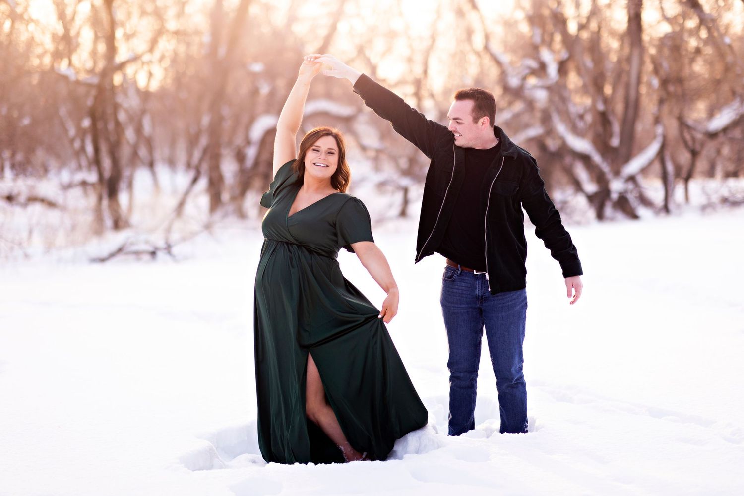 Winter maternity photoshoot in snowy outdoor setting.