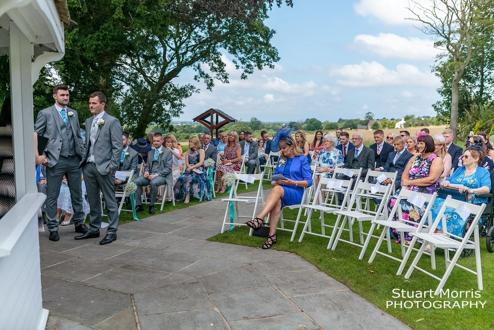 Wedding guests waiting during the outdoor wedding ceremony at west tower Ormskirk  wedding venue.