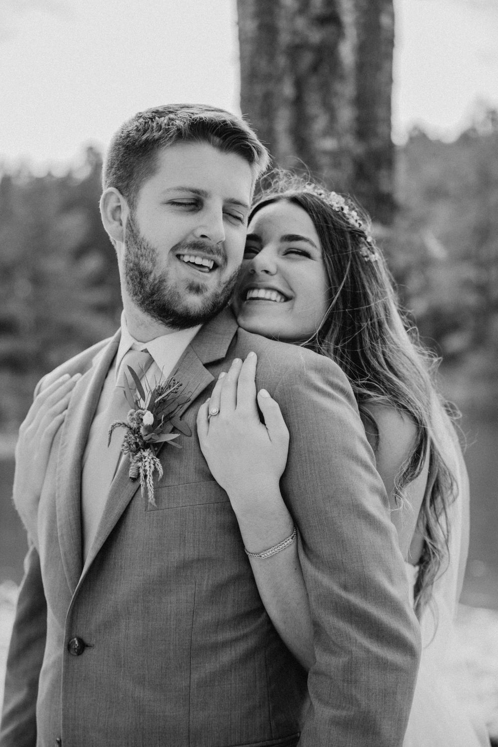 Black and white romantic moment captured during outdoor wedding photoshoot.