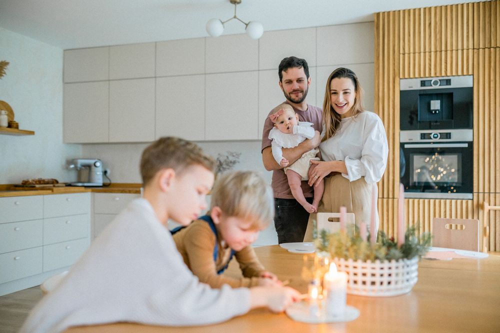 Casual family moment in modern kitchen with birthday celebration.