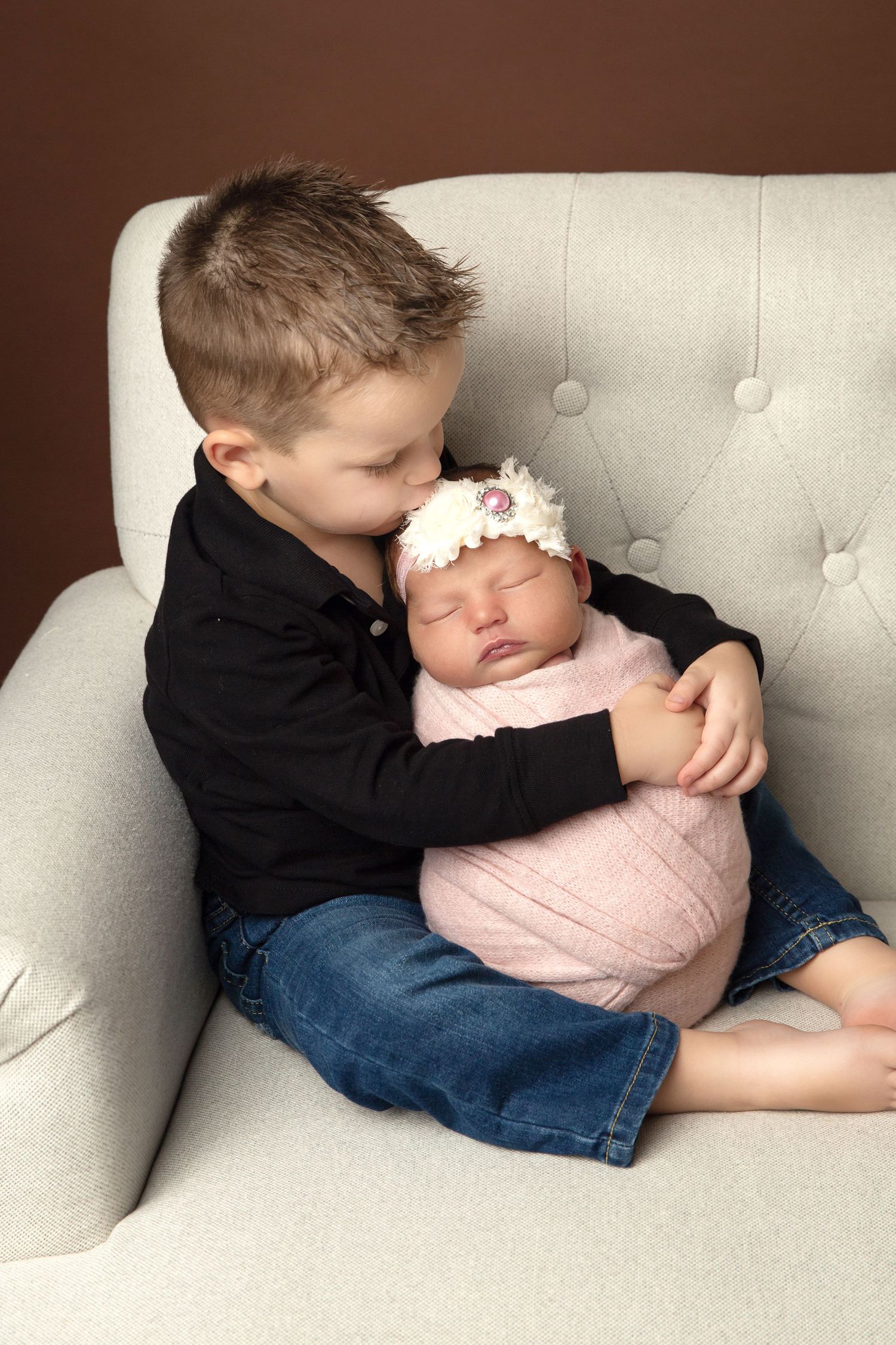 Toddler holding Newborn baby sister Portrait