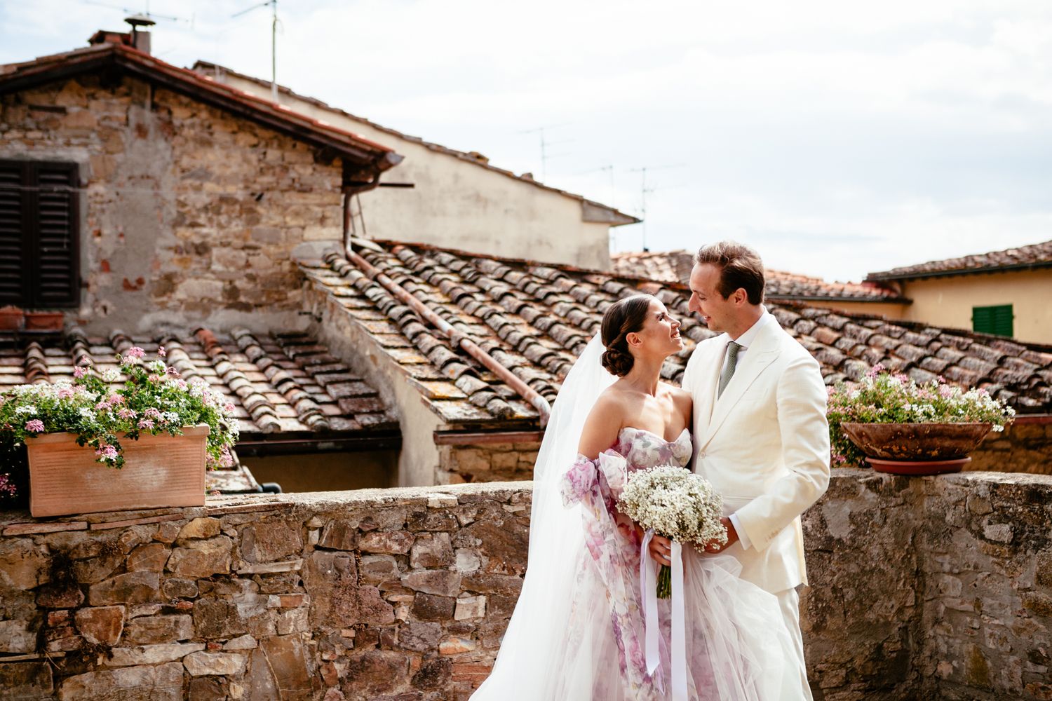 bride and groom with a view of the roofs in Panzano Chianti Tuscany Italy