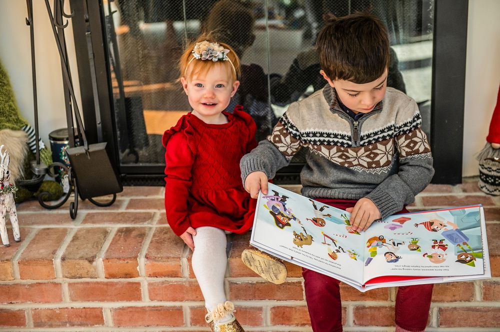 Reading moment on front porch with holiday decor and winter sweaters.
