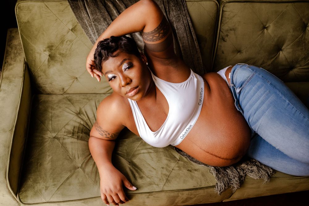 Black woman maternity session in natural light studio casual beautiful