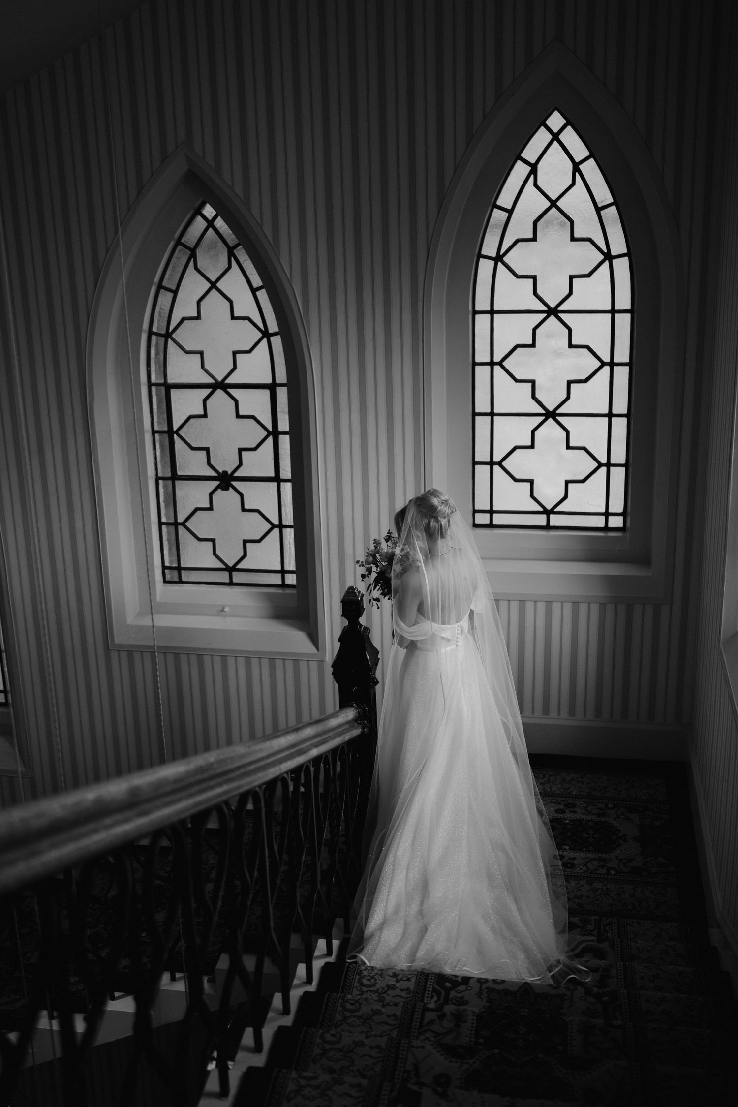 bride descending stairs at the Randolph hotel in Oxford