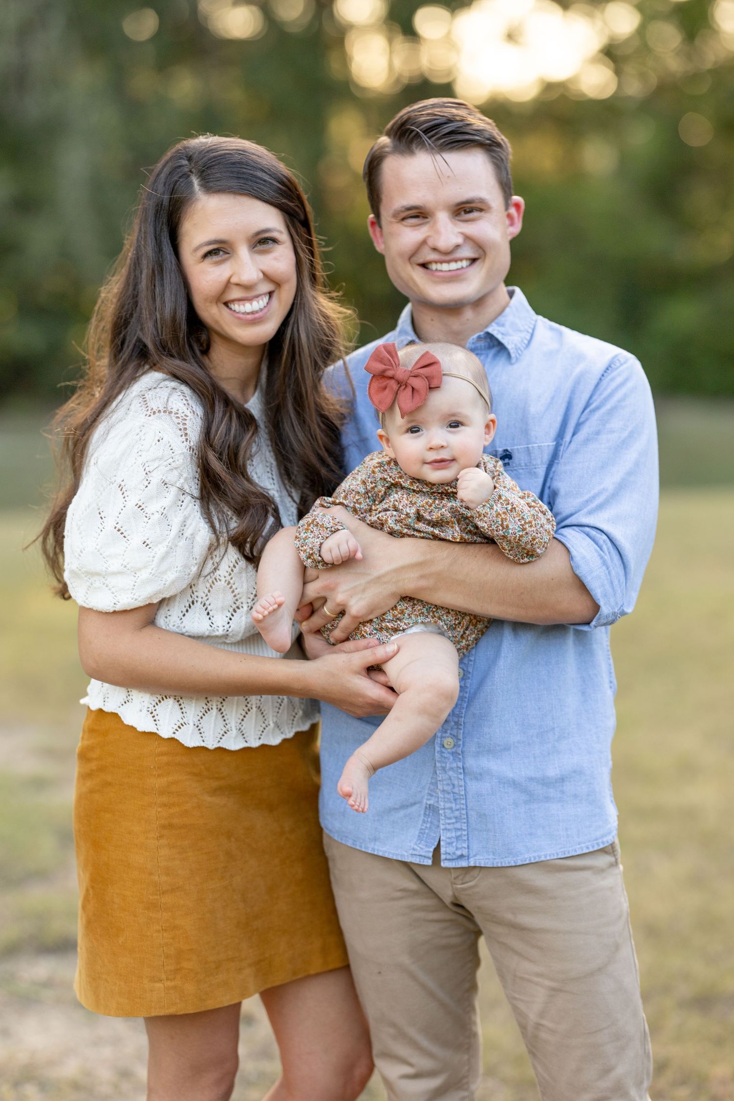 Family Photo in the park with young baby dressed in fall colors and tones