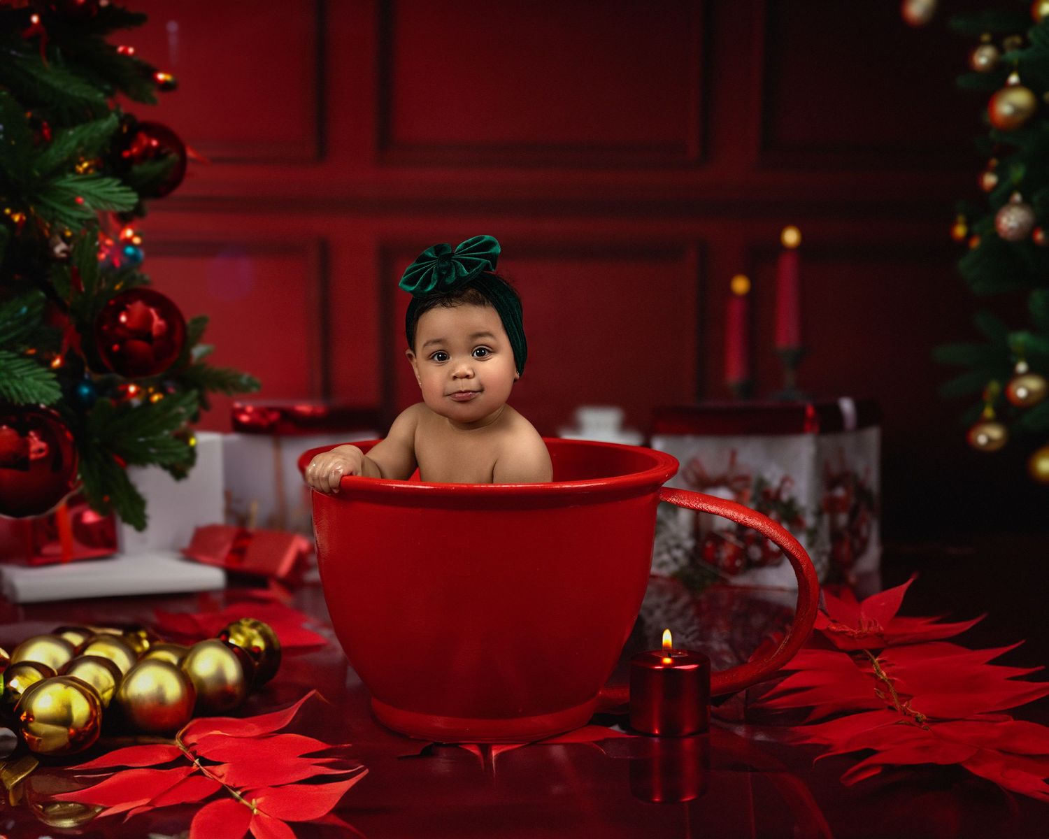 Festive Christmas photo featuring a large red teacup with holiday decorations and golden ornaments.
