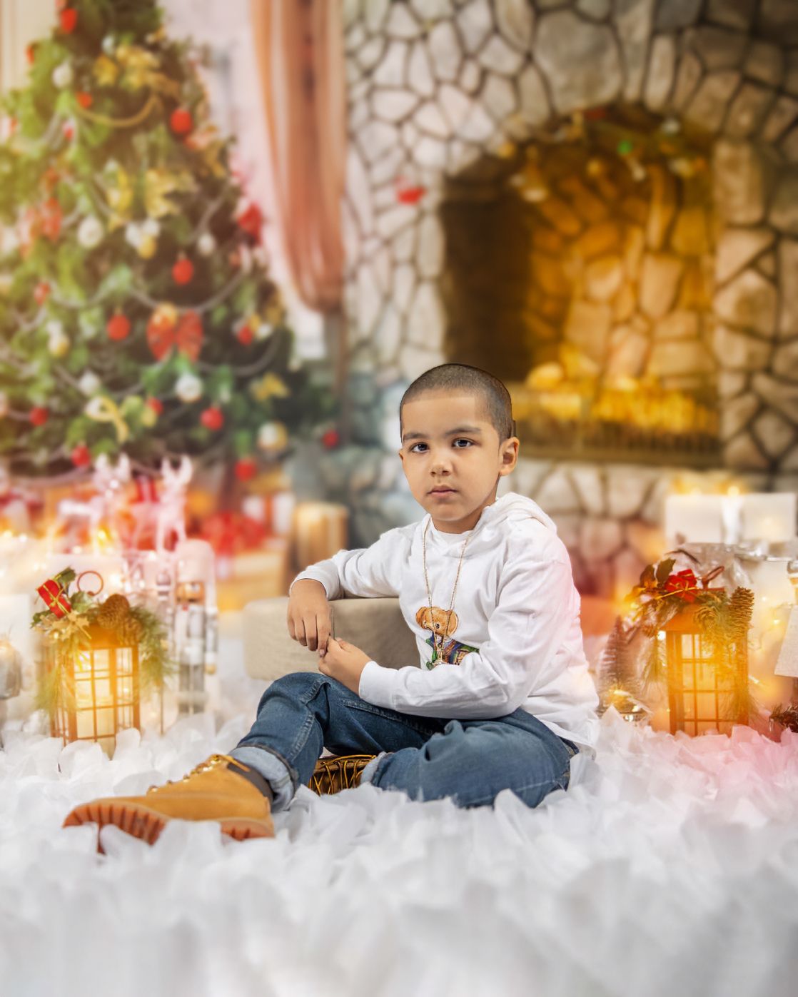 Holiday portrait setup with decorated Christmas tree, stone fireplace, and lanterns creating a cozy scene.