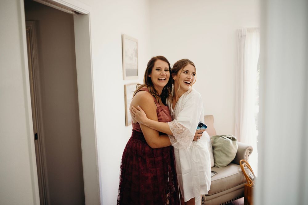 Wedding party members sharing joyful moments during preparation time.