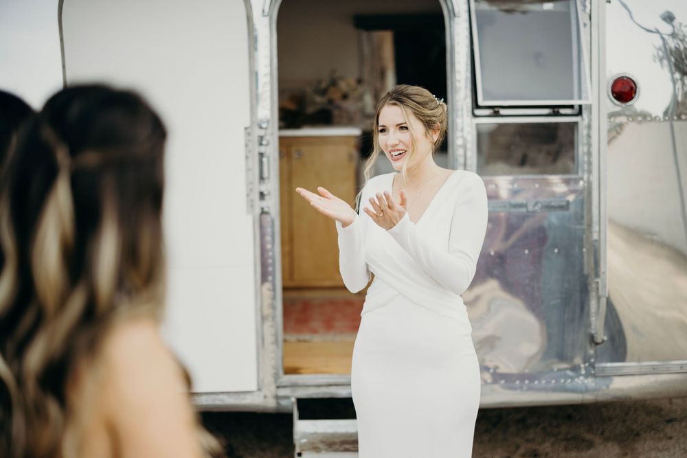 Wedding day preparations taking place inside vintage silver Airstream trailer.