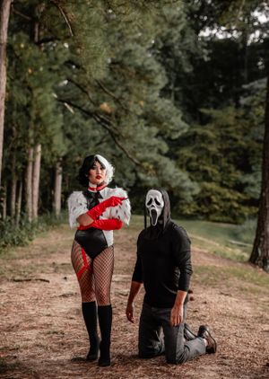 A cosplay photoshoot in a forest setting featuring dark and dramatic Halloween-themed costumes.