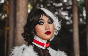 A dramatic forest photoshoot with black and white themed costume details.