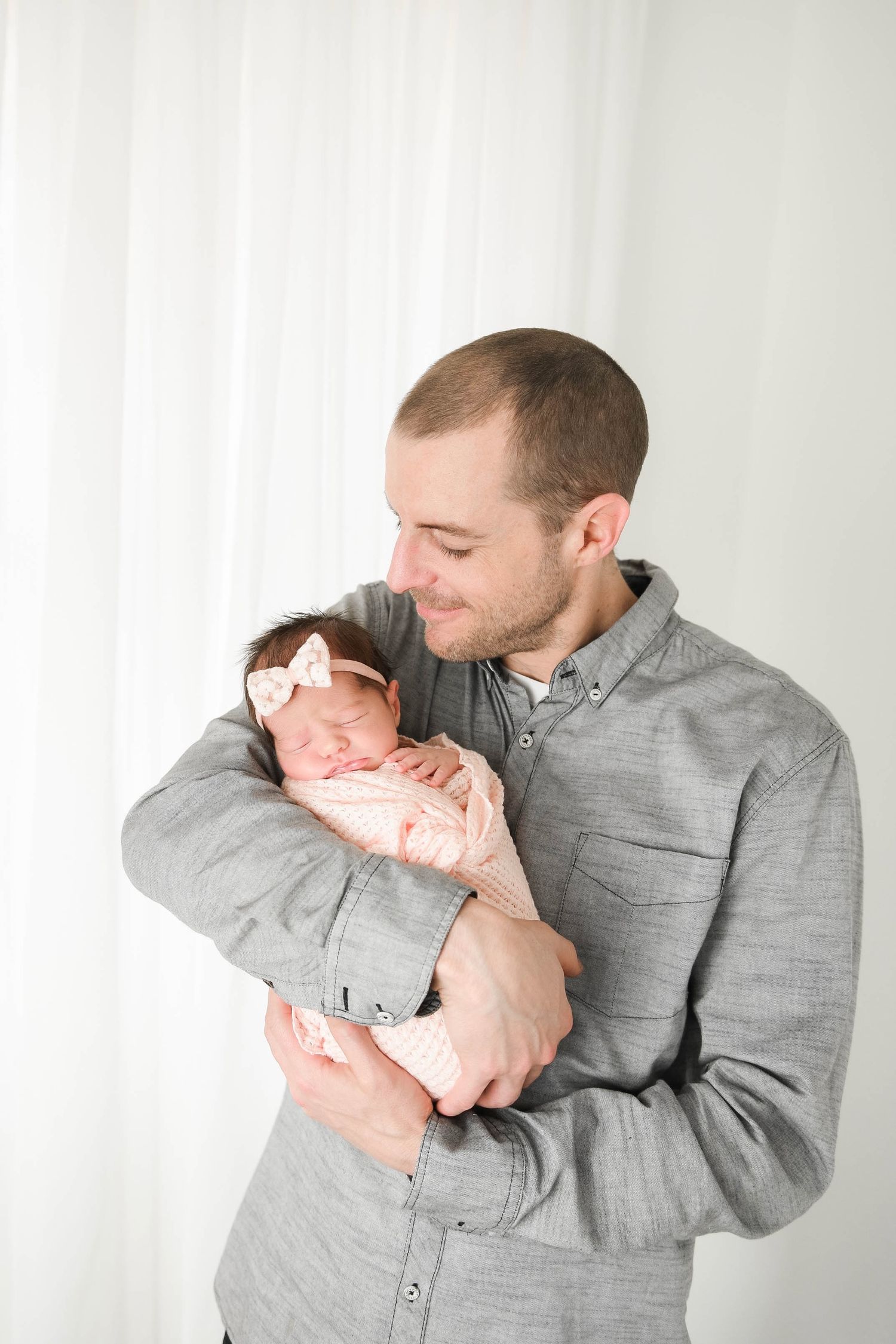 dad holding his newborn girl