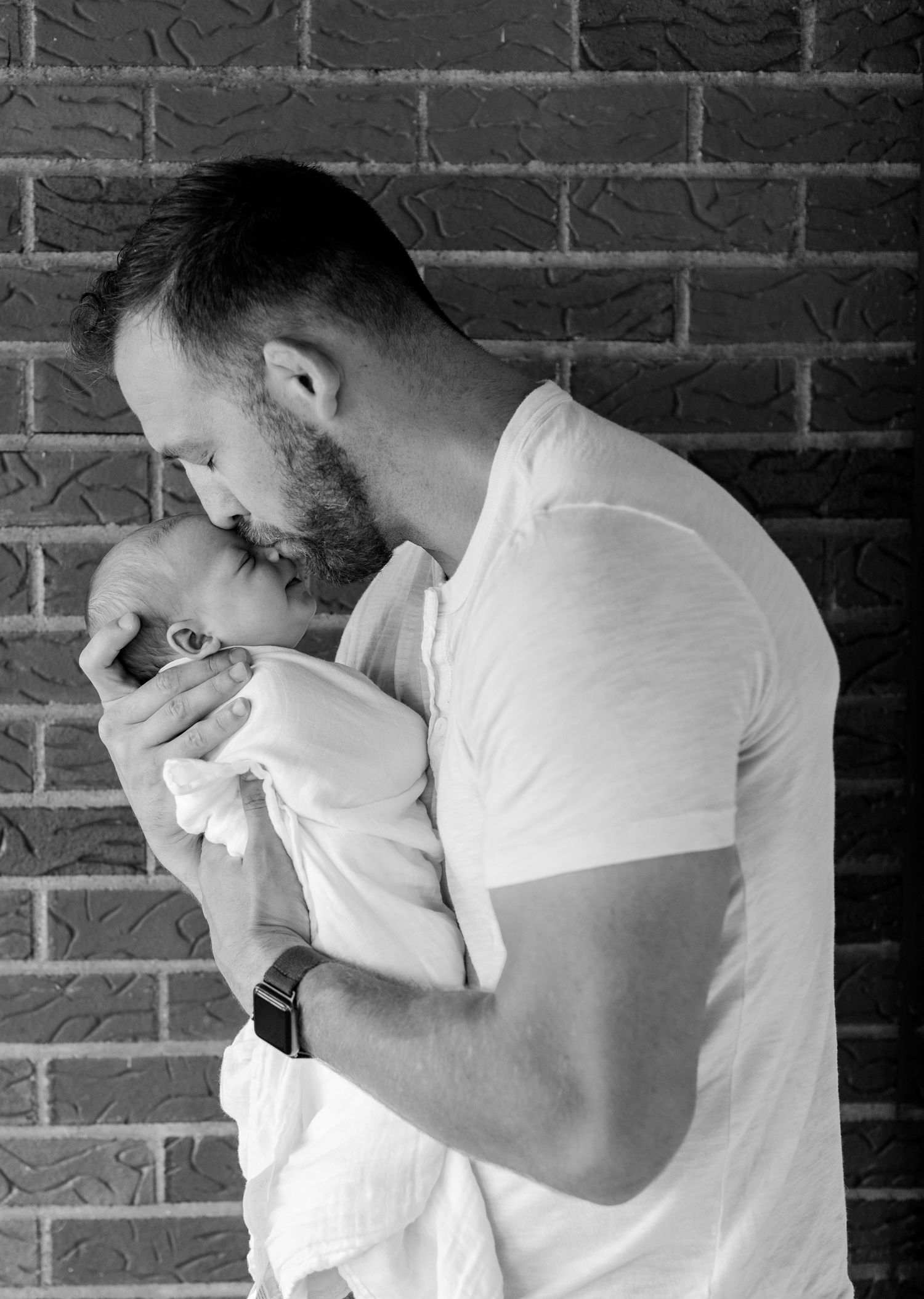 Black and white series showing emotional reactions against brick wall background.