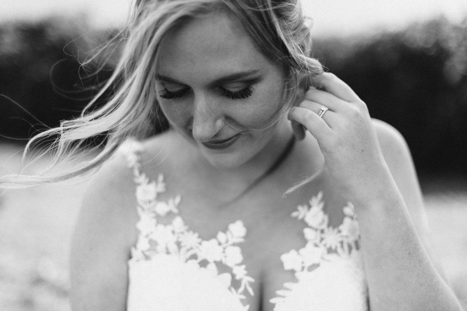 Close-up black and white portrait of bride in delicate lace wedding dress.