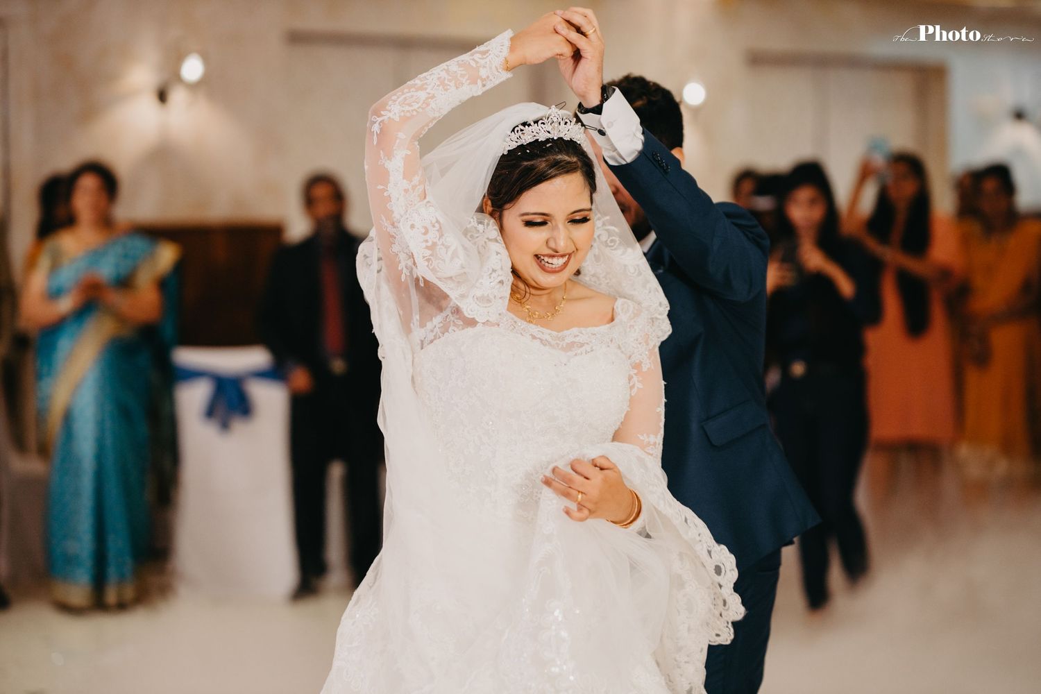 Elegant wedding reception dance captured in soft, romantic lighting with lace details.
