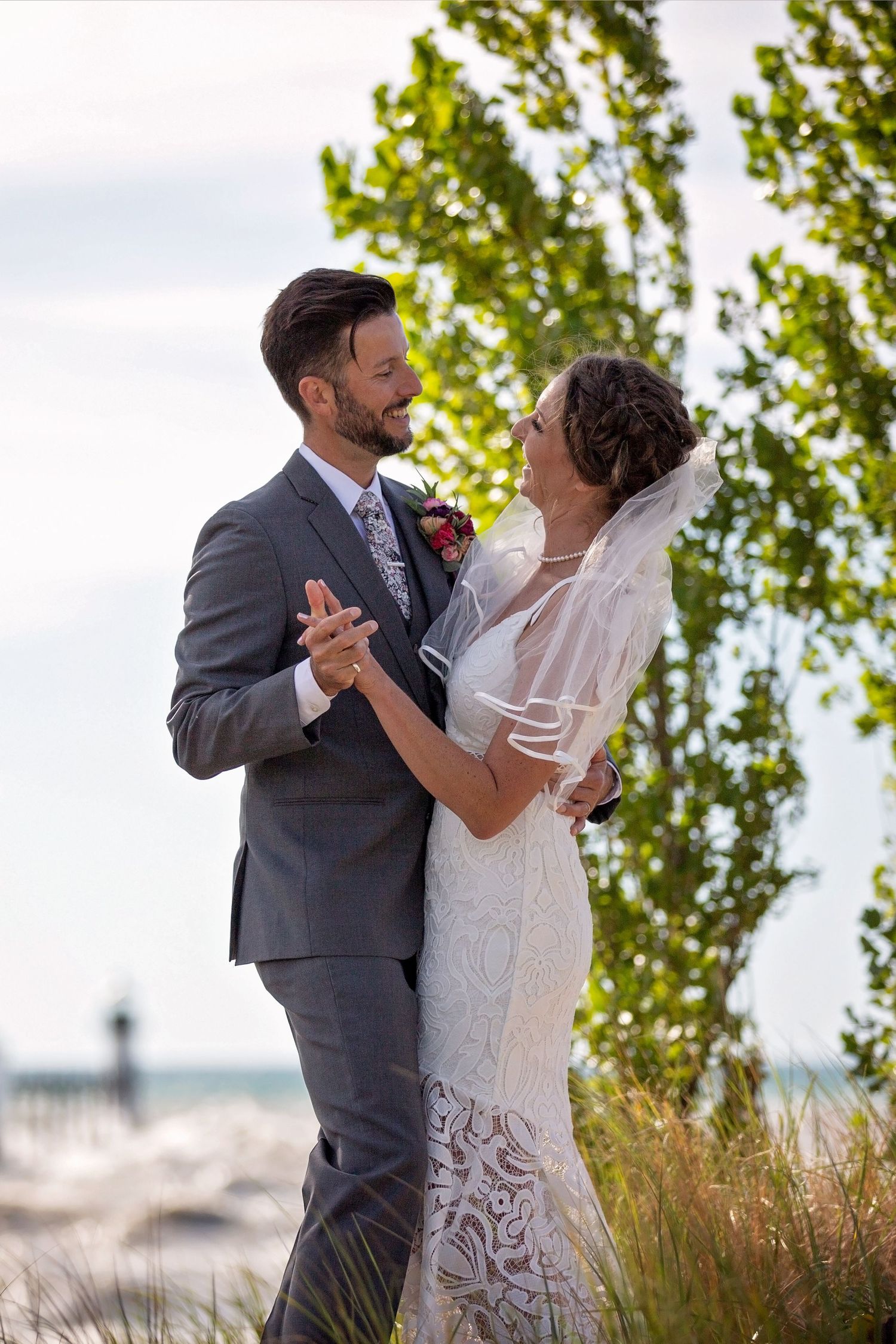 Couple shares romantic dance moment during outdoor wedding.