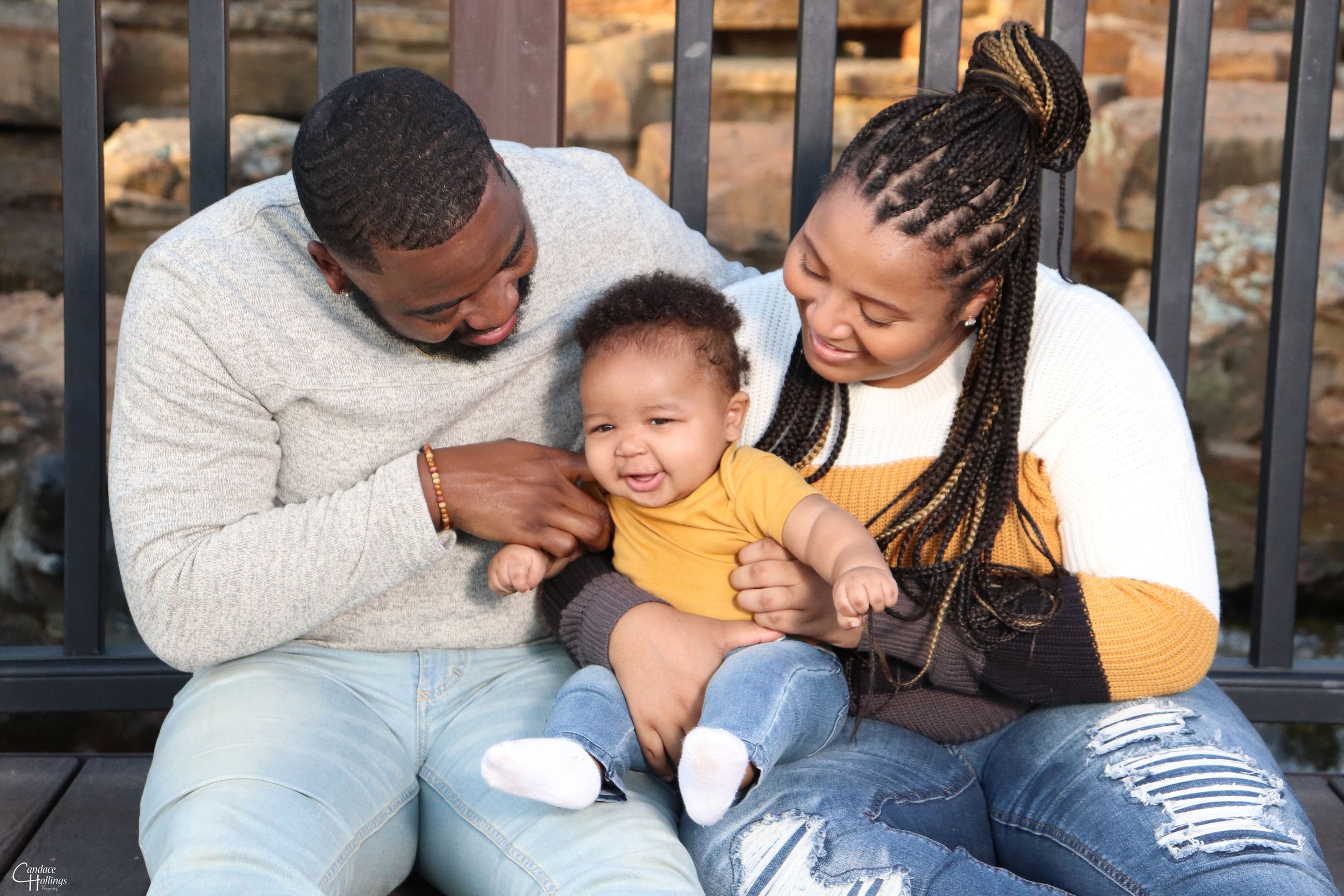 Family sharing joyful moment together on outdoor bench.