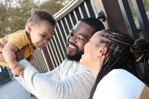 Family enjoying tender moment together outdoors.
