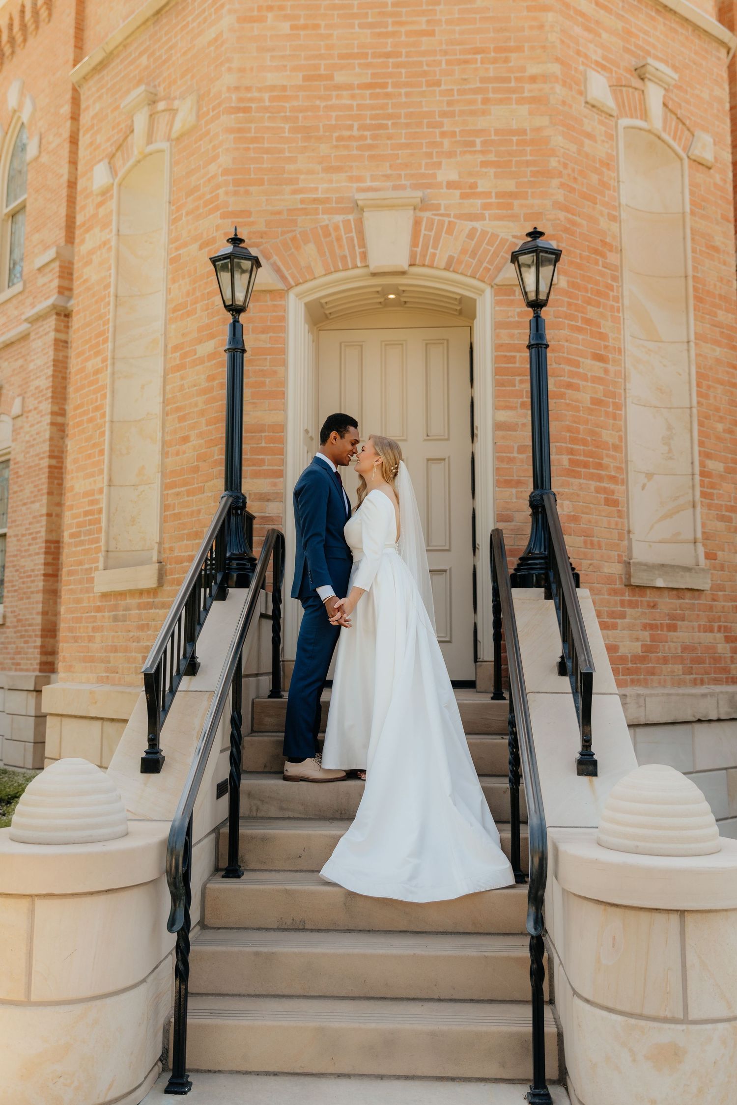 Bride and Groom gazing at each other, hands held, on steps at Provo City Center LDS Temple