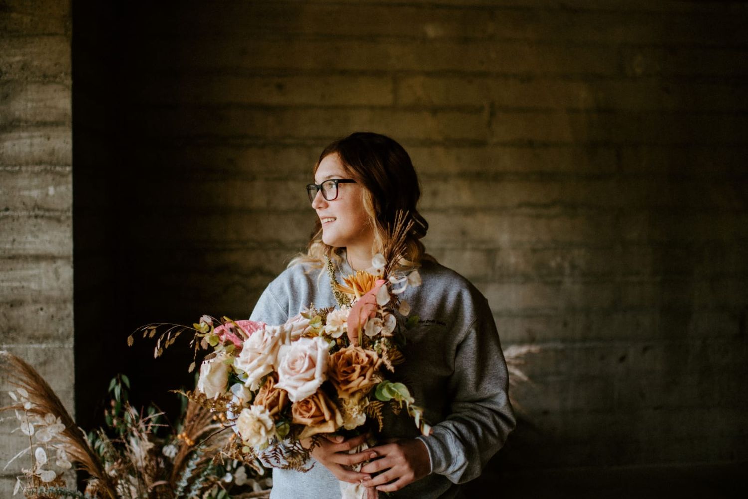 Adventure, Elopement and Boudoir Photographer owner holding beautiful bouquet