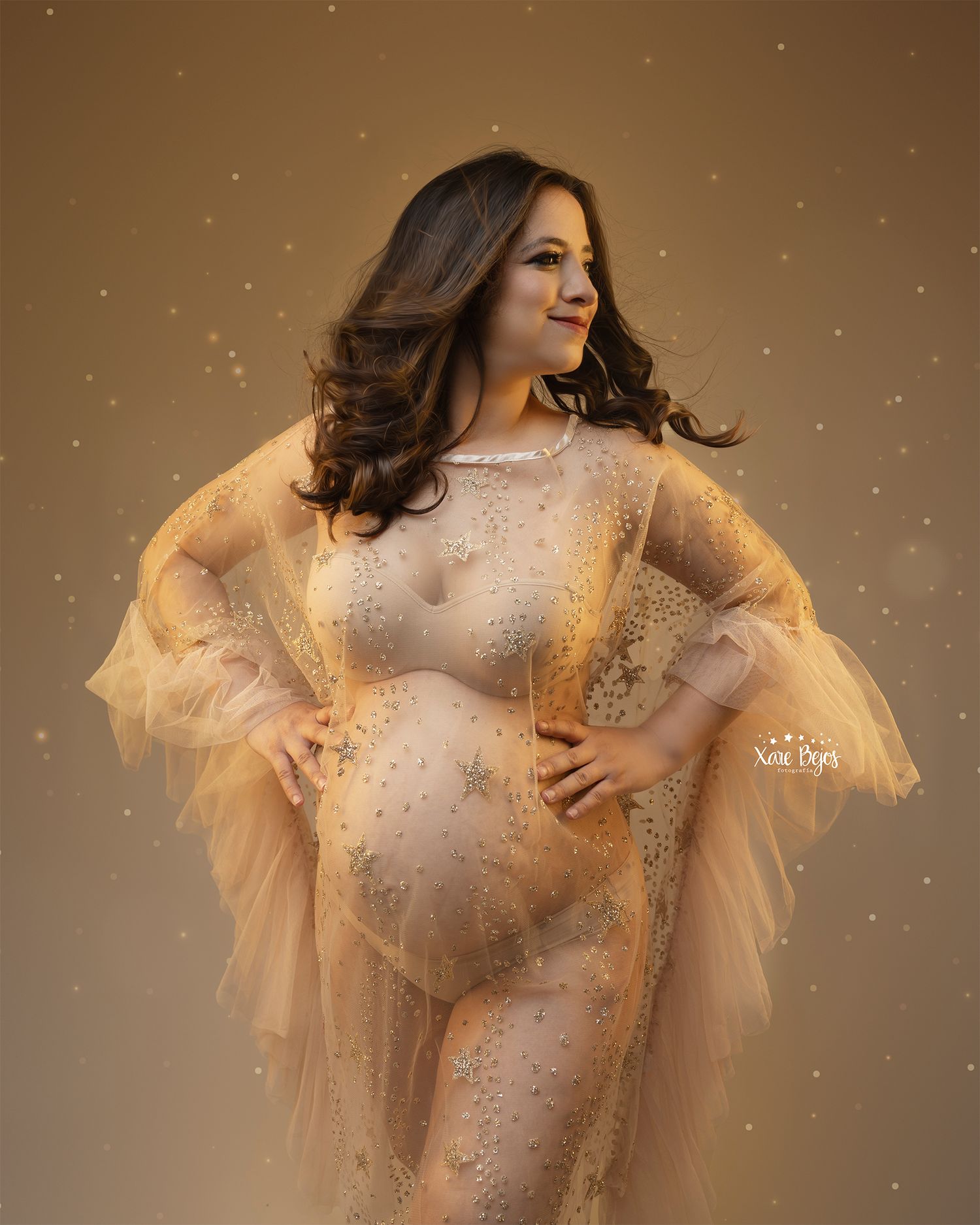 Ethereal fashion photo with sheer golden dress and sparkling details against warm background.