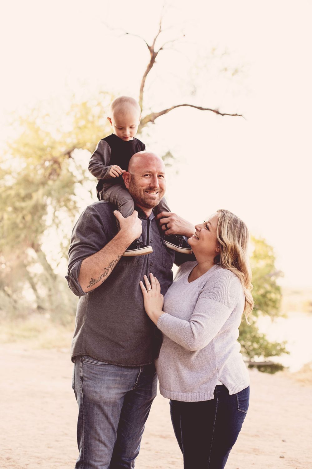 Joyful family lifestyle session with warm sunset lighting in desert setting.