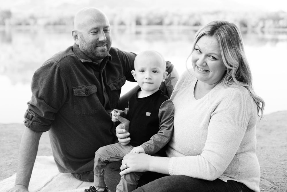 Black and white family portraits showing tender moments outdoors.