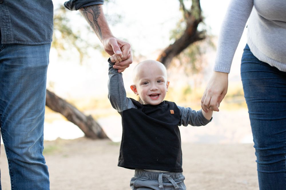 Casual outdoor family photo session with natural interactions and movement.