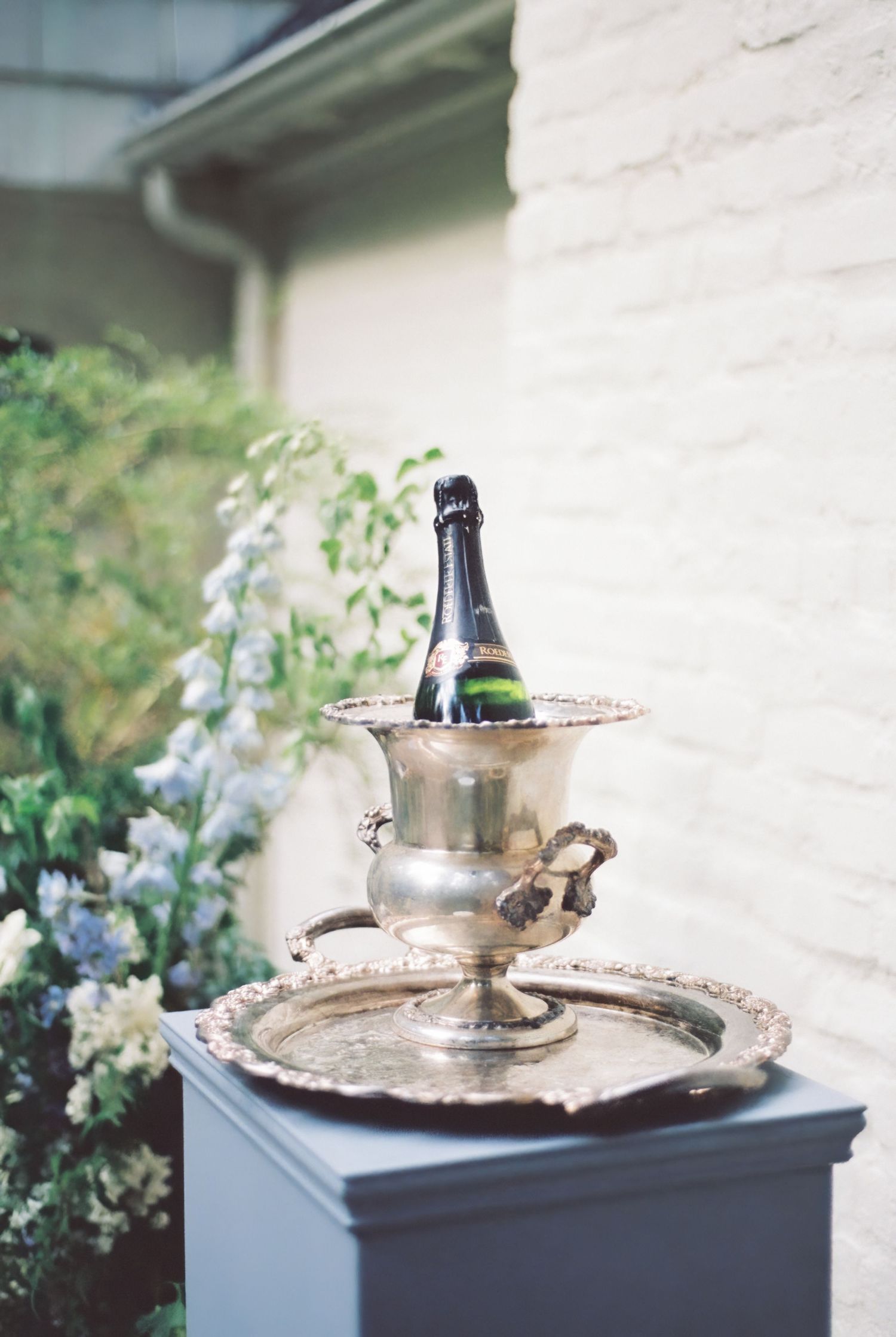 Luxury wedding detail photo of a champagne bottle in bucket of ice.