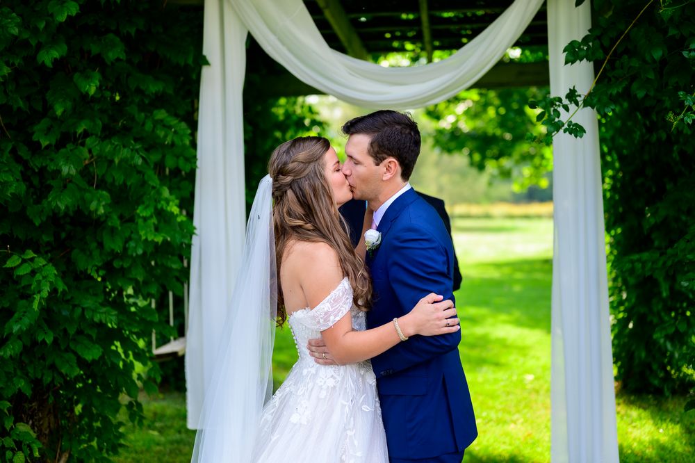 London Wedding Photographer Arrowwwod Farm Bride and Groom Kiss at Ceremony Spirits Intrigued Photography 2022