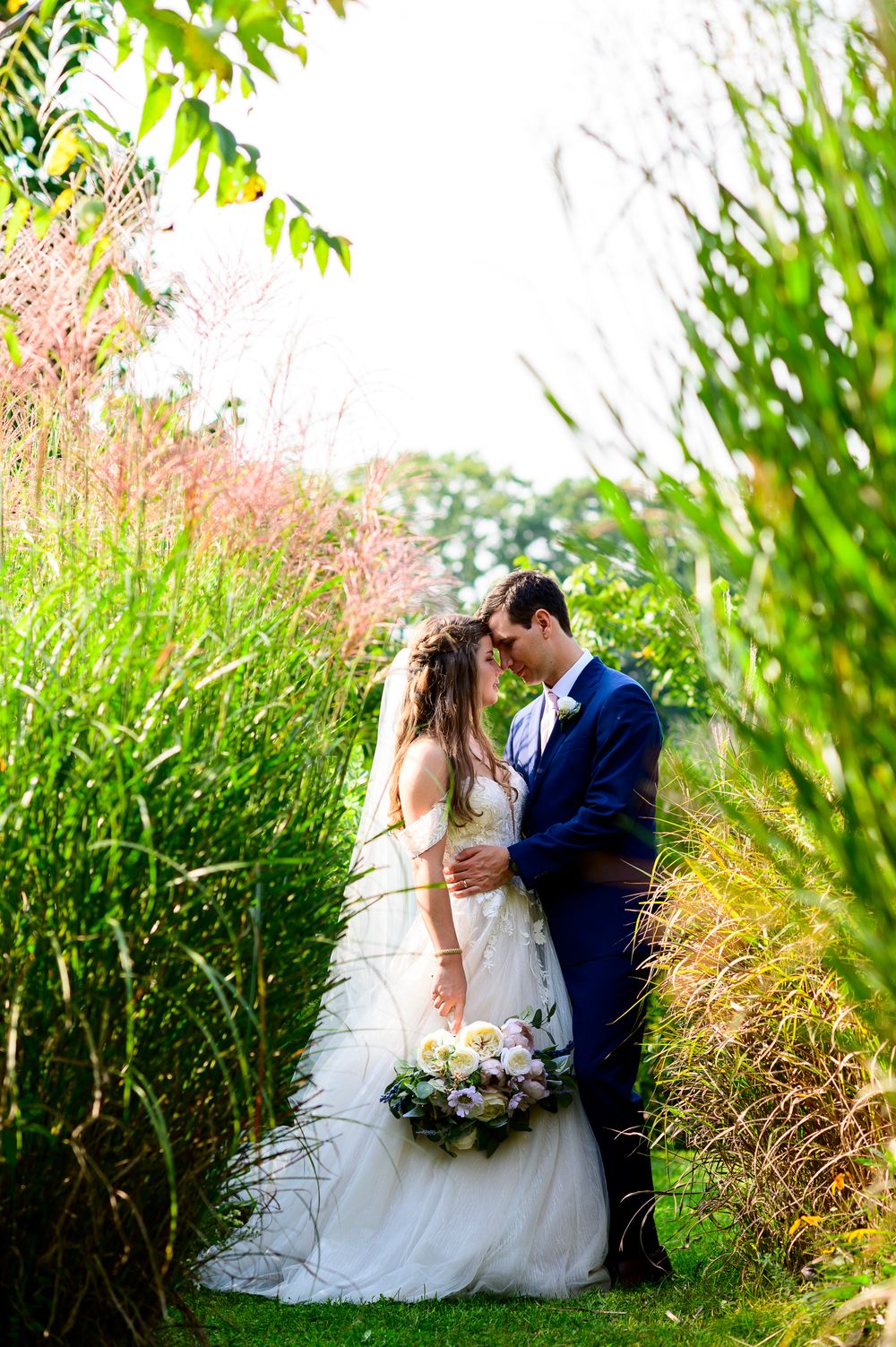 London Wedding Photographer Arrowwwod Farm Bride and Groom Standing by Tall Grass Spirits Intrigued Photography 2022